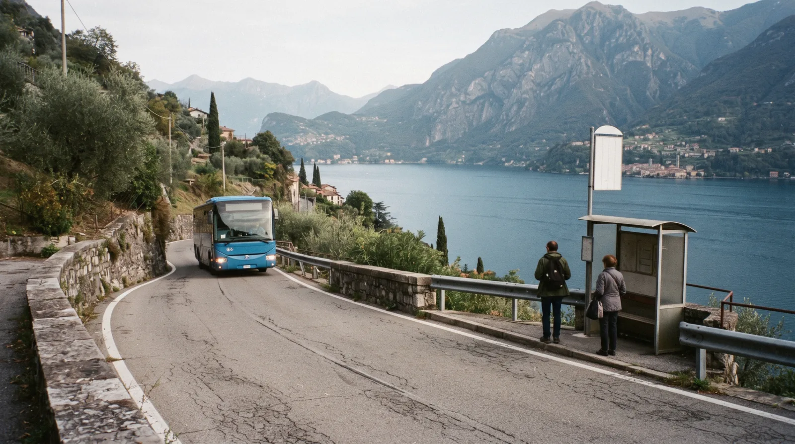A shore road and a lakeside railway running below terraced villages, the road and rail options for getting around Lake Como
