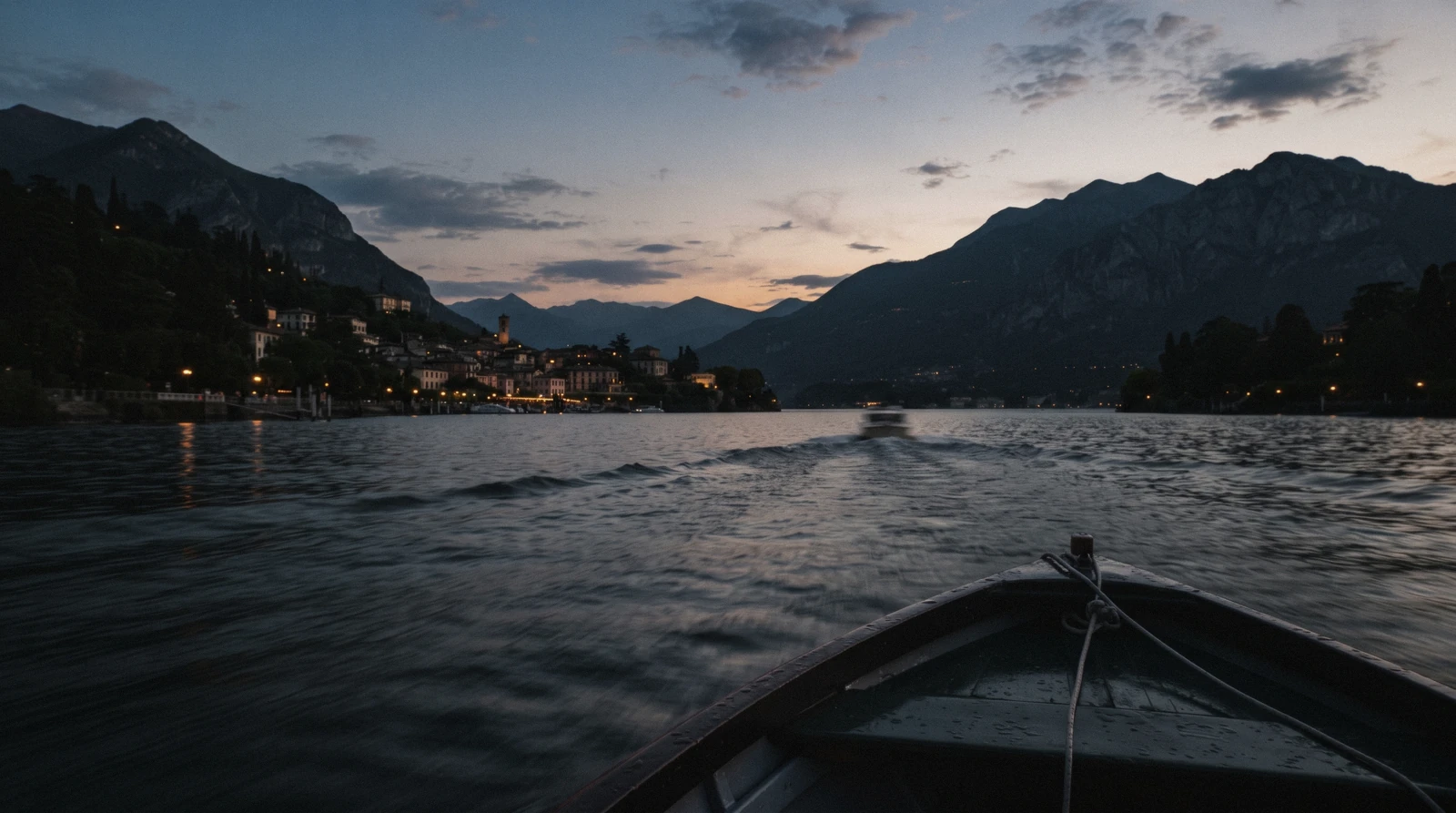 A slow boat crossing the centre of the lake between wooded headlands at golden hour, the view that answers whether Lake Como is worth visiting