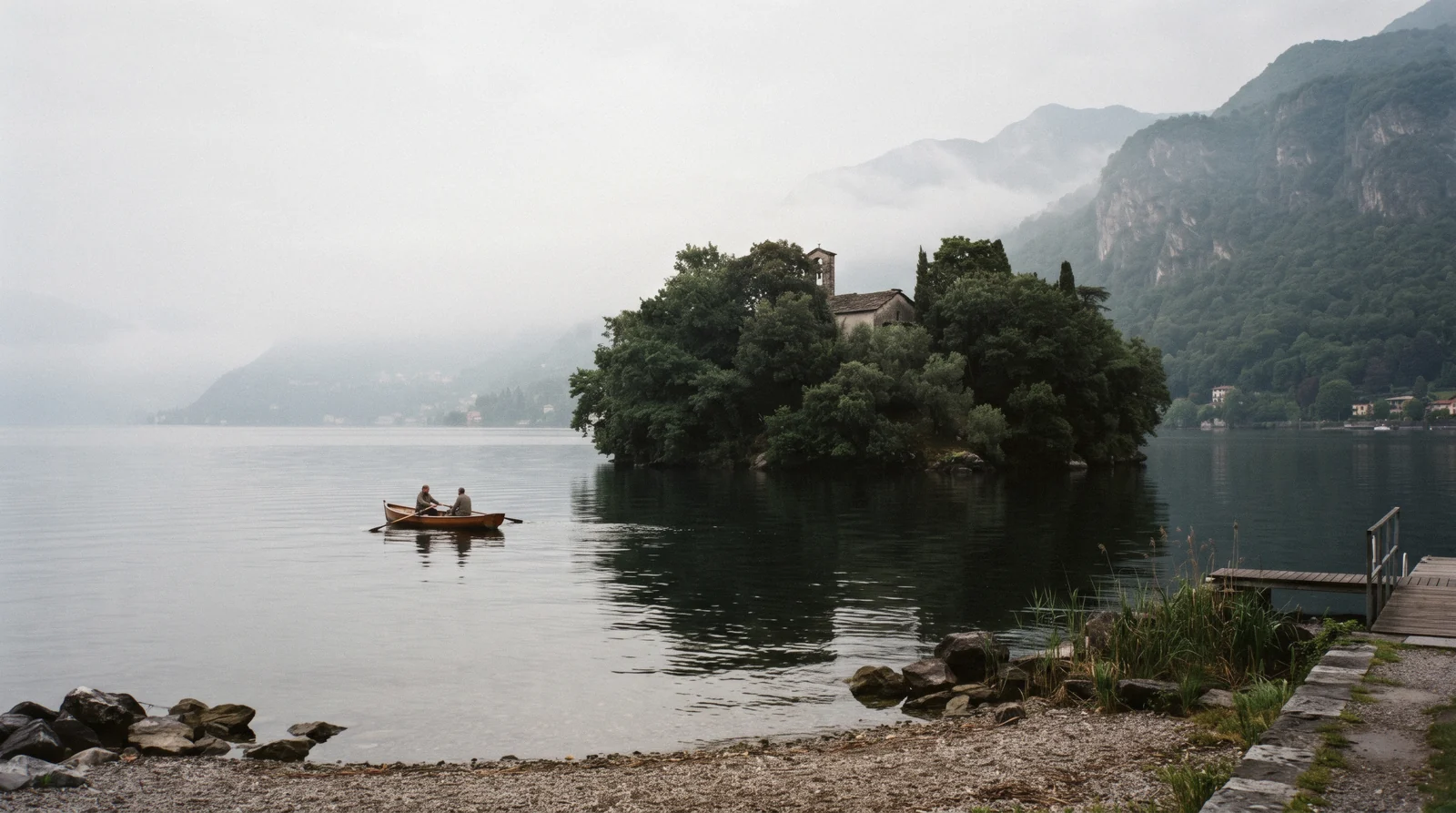 The low wooded shape of Isola Comacina in the lake off Ossuccio, the island destroyed in 1169 and never rebuilt