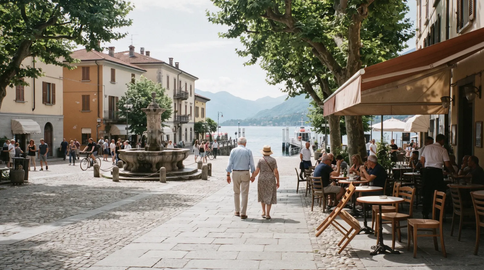 The waterfront promenade and pastel facades of Menaggio with the mountains of the eastern shore behind