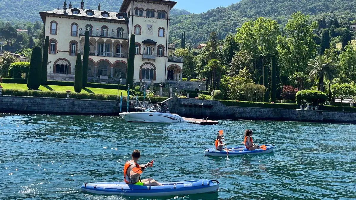 Kayaks pulled up on the shore at Bellagio with Lake Como behind